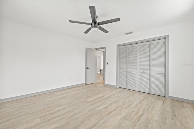 unfurnished bedroom with ceiling fan, light hardwood / wood-style floors, and a closet