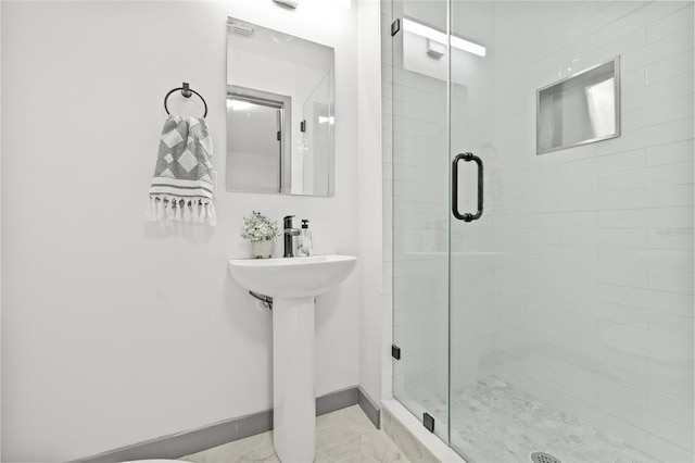 bathroom featuring a shower with door