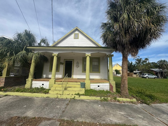 bungalow featuring a front lawn and covered porch