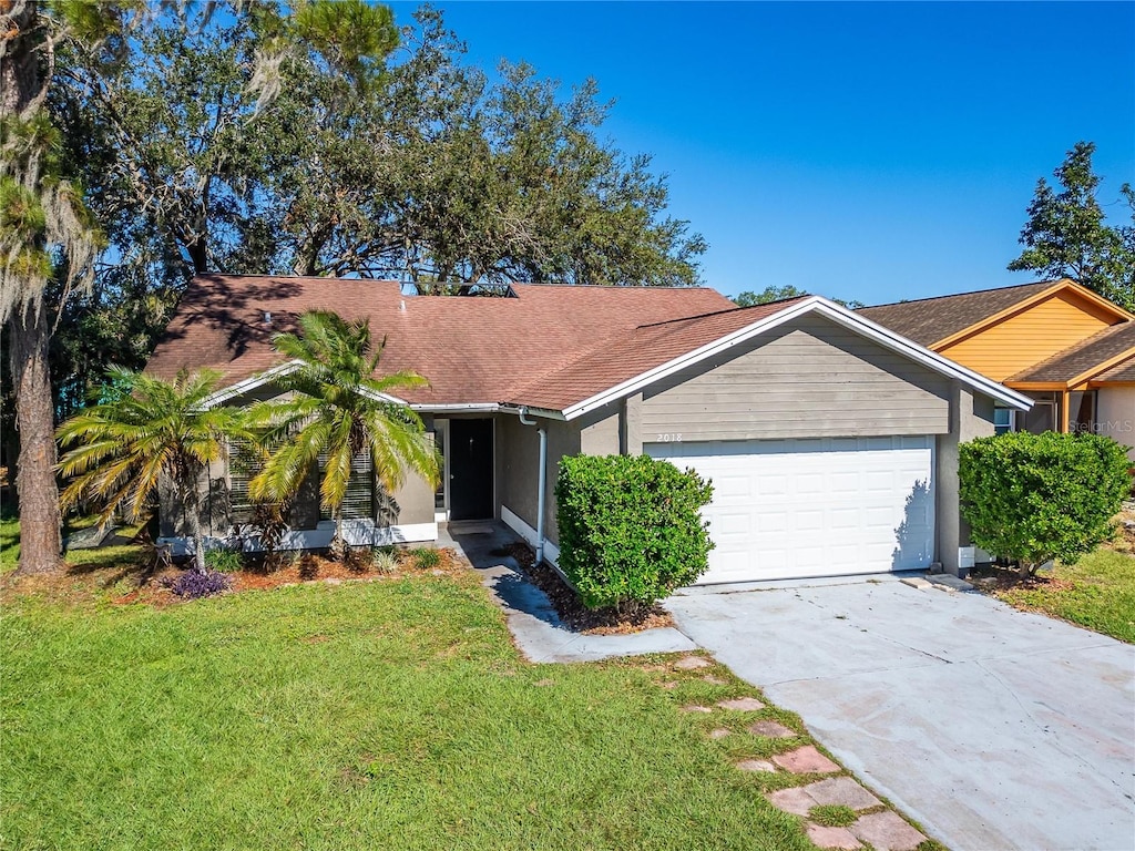 ranch-style home with a garage and a front yard