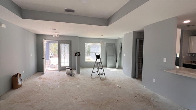 interior space featuring visible vents and a raised ceiling