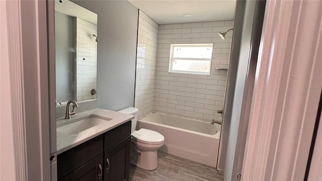 bathroom with a textured ceiling, vanity, toilet, and shower / bathtub combination