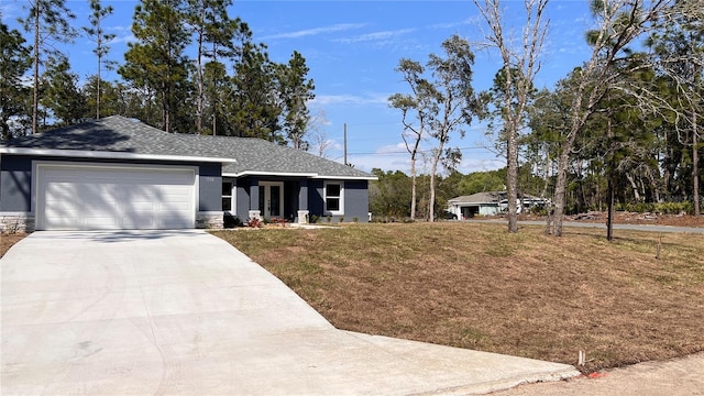 ranch-style house featuring roof with shingles, stucco siding, concrete driveway, a front yard, and a garage