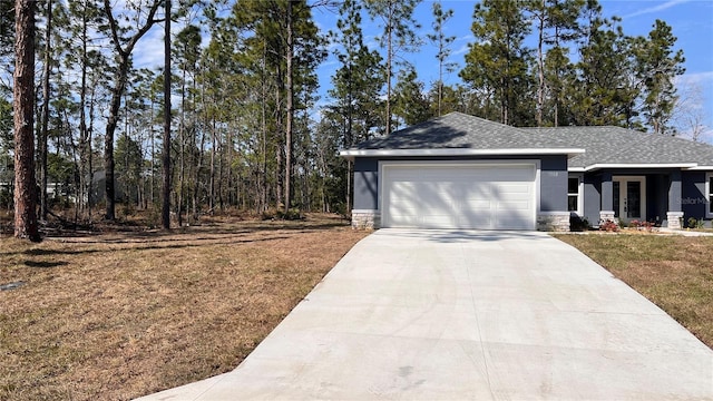 exterior space with french doors, a shingled roof, an attached garage, a front yard, and driveway