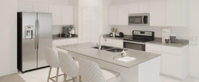 kitchen with sink, a center island with sink, white cabinets, and appliances with stainless steel finishes