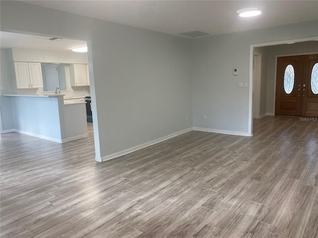 unfurnished living room featuring light wood-type flooring