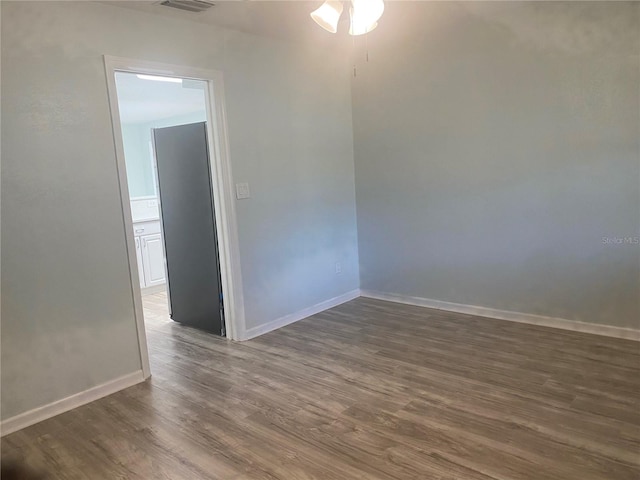 unfurnished room featuring dark wood-type flooring