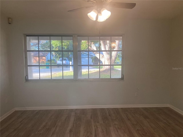 unfurnished room featuring ceiling fan and dark wood-type flooring