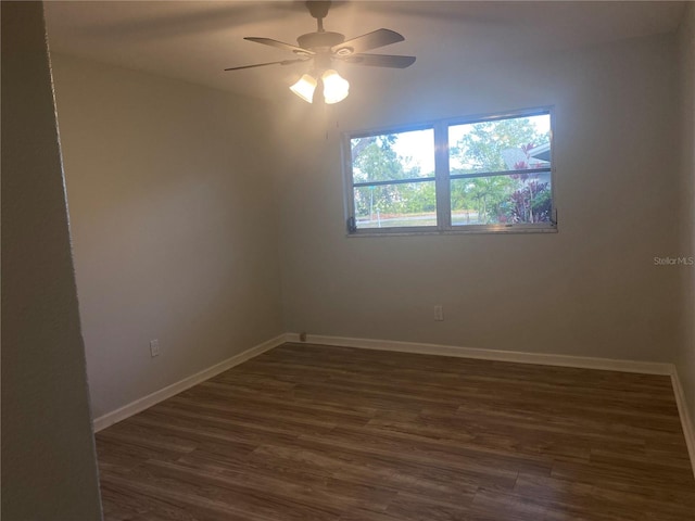 spare room with ceiling fan and dark hardwood / wood-style flooring