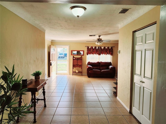 hall featuring light tile patterned floors