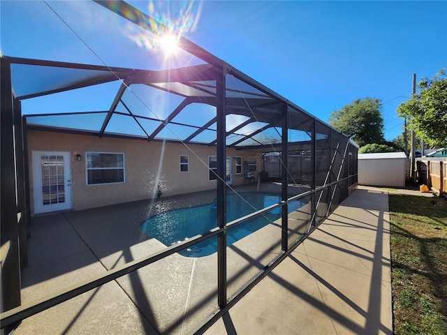 pool with a lanai, a patio, and fence