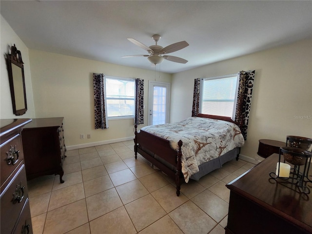 bedroom featuring multiple windows, baseboards, and light tile patterned flooring