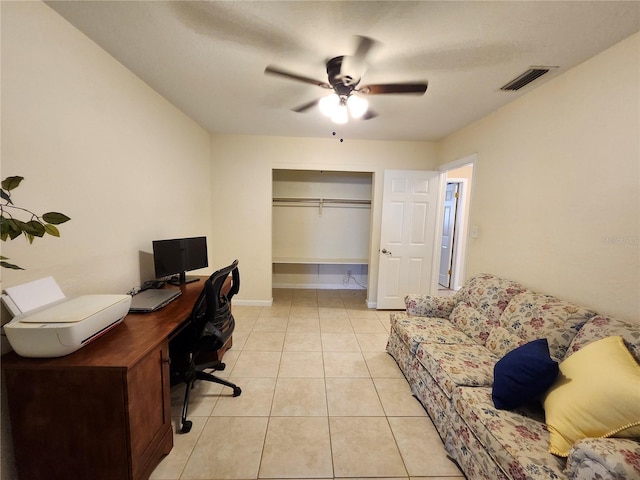 office space with light tile patterned floors, baseboards, visible vents, and a ceiling fan