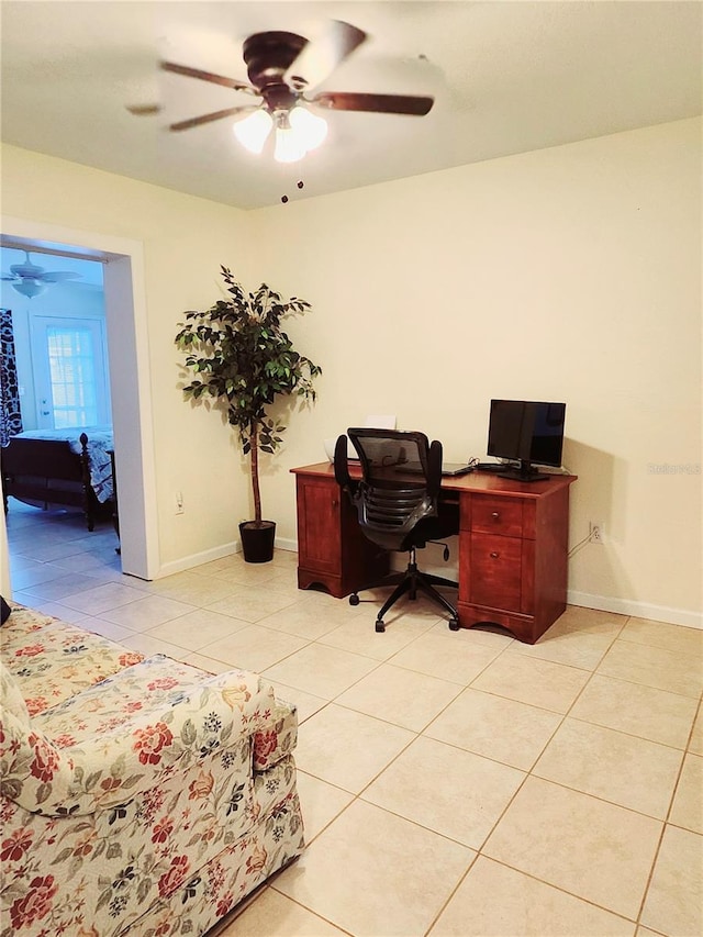 office area featuring light tile patterned floors, ceiling fan, and baseboards