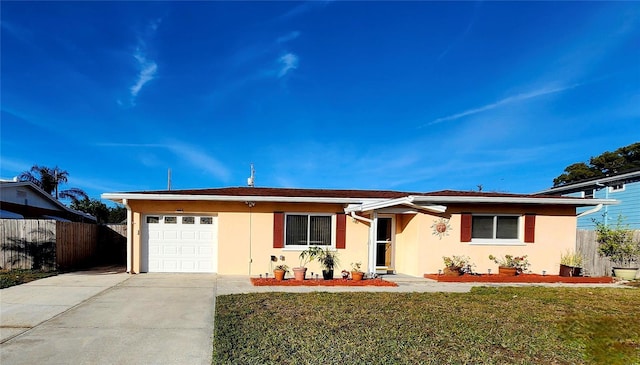 ranch-style house featuring a garage, fence, concrete driveway, stucco siding, and a front lawn