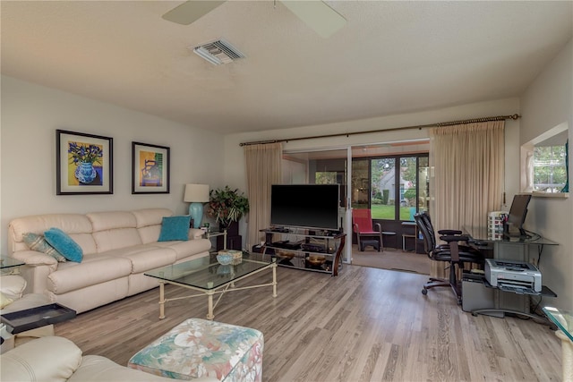 living room featuring a wealth of natural light and light hardwood / wood-style floors