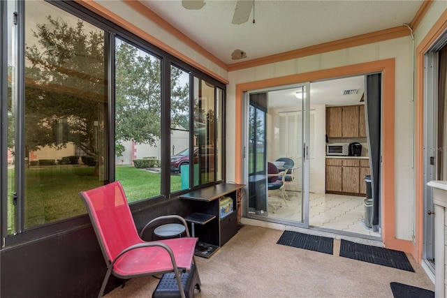 sunroom featuring plenty of natural light and ceiling fan