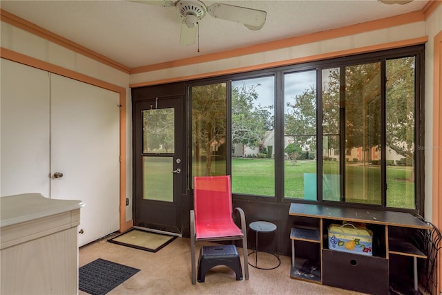 sunroom / solarium featuring ceiling fan