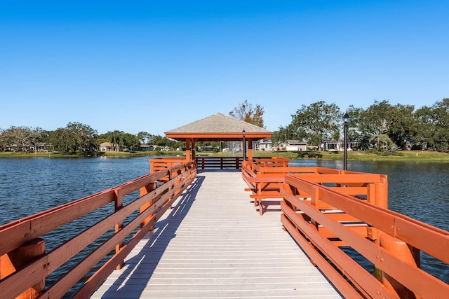 view of dock with a gazebo and a water view