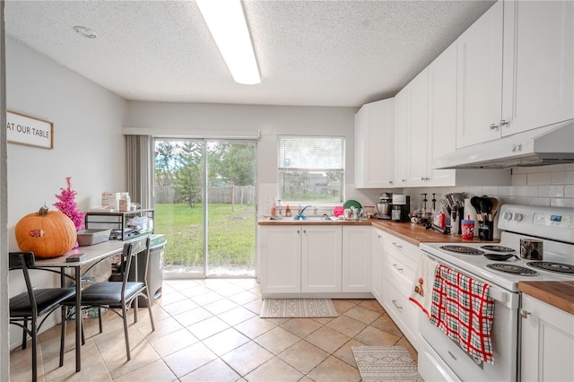 kitchen featuring butcher block countertops, white range with electric cooktop, and white cabinetry