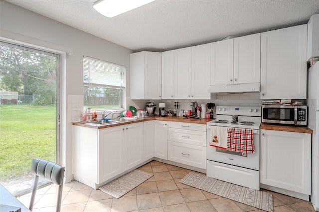 kitchen with white cabinetry, sink, white appliances, decorative backsplash, and light tile patterned floors