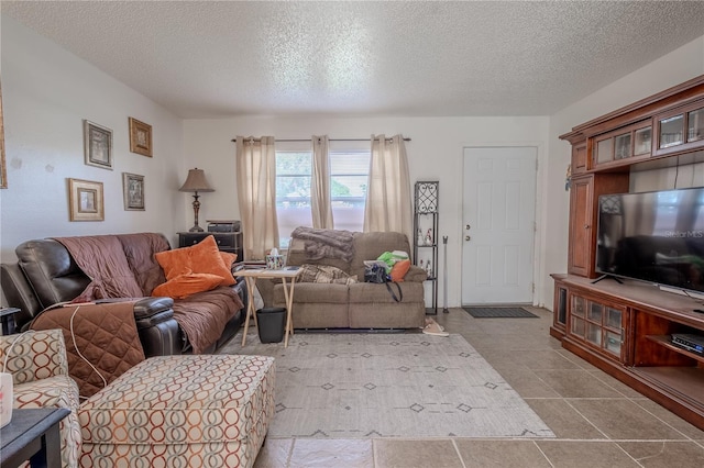 living room featuring light tile patterned floors and a textured ceiling