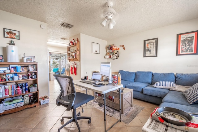 tiled home office with a textured ceiling