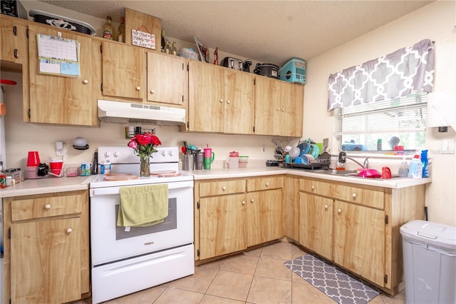 kitchen featuring light brown cabinetry, white electric range oven, a textured ceiling, sink, and light tile patterned floors