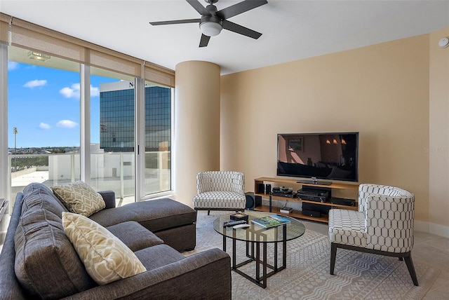 living room featuring ceiling fan and a wall of windows