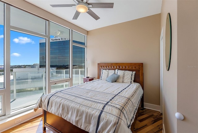 bedroom with ceiling fan and hardwood / wood-style floors