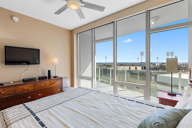 bedroom featuring ceiling fan and access to exterior