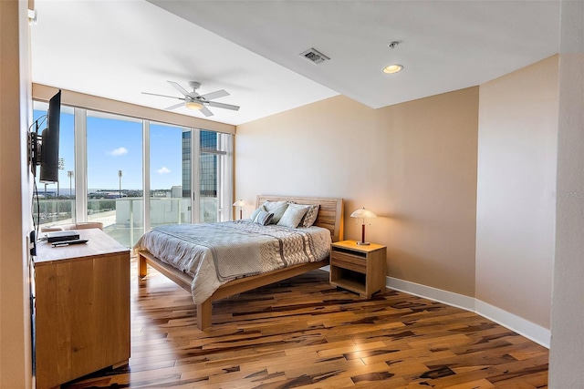 bedroom featuring dark hardwood / wood-style floors, ceiling fan, and access to exterior