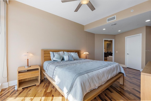 bedroom with hardwood / wood-style flooring and ceiling fan