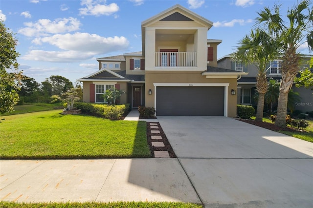 view of front of property featuring a balcony, a front lawn, and a garage