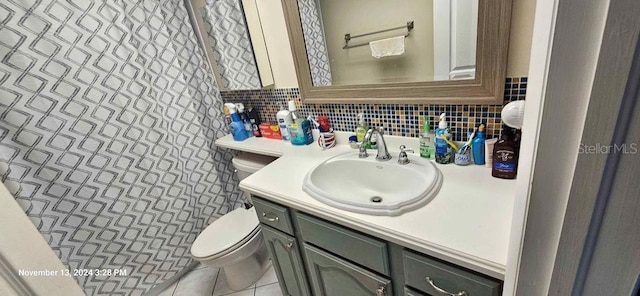 bathroom featuring toilet, vanity, tasteful backsplash, and tile patterned floors