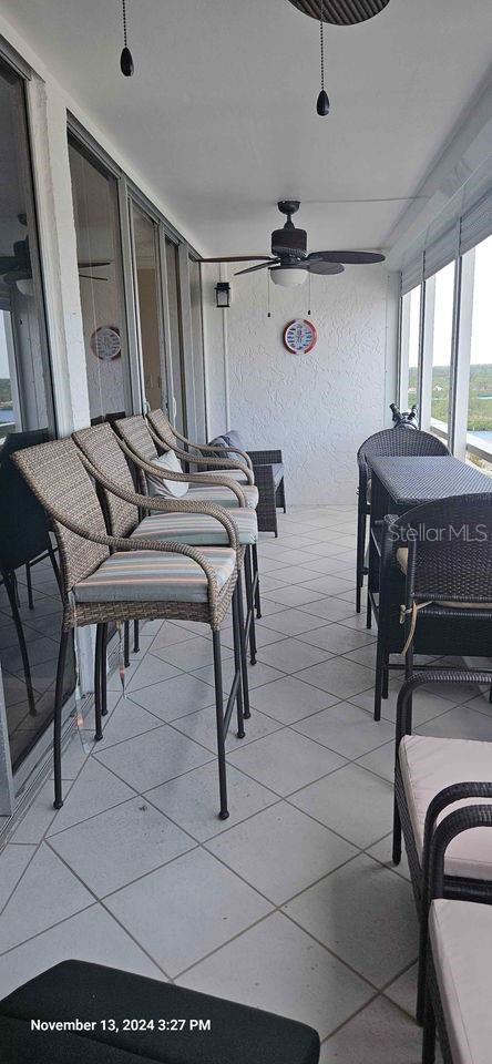 17920 Gulf Blvd Unit 1508, Redington Shores, FL 33708 - sunroom / solarium featuring ceiling fan, tile patterned floors, and a textured wall