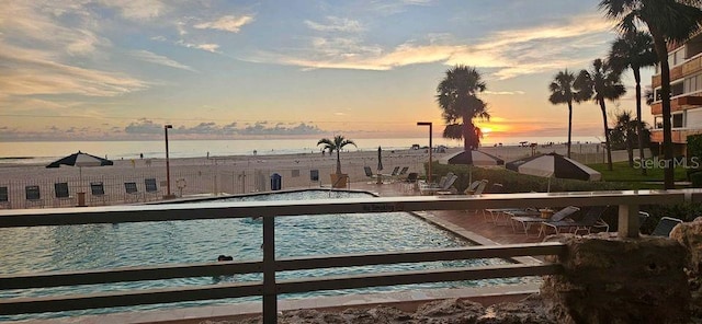 pool at dusk with a water view