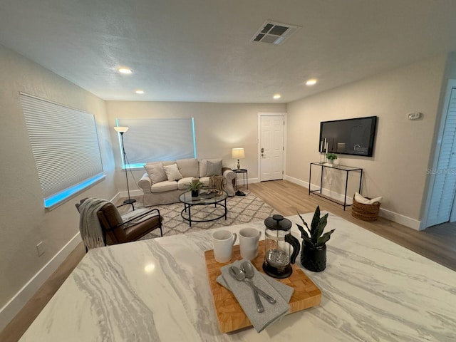 living room with vaulted ceiling and hardwood / wood-style flooring