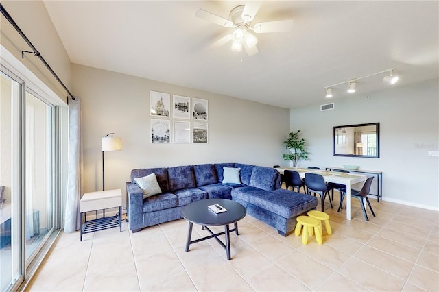 living room featuring ceiling fan and light tile patterned floors