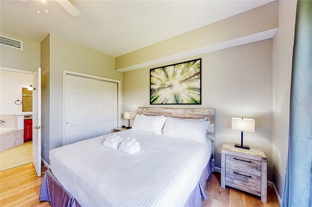 bedroom with ceiling fan, wood-type flooring, and a closet