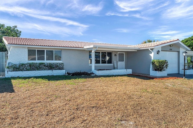 view of front of property with a front yard and a garage