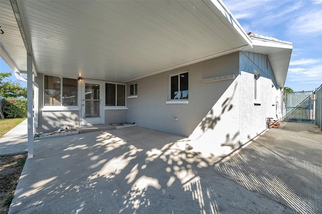 back of property with a patio and a sunroom