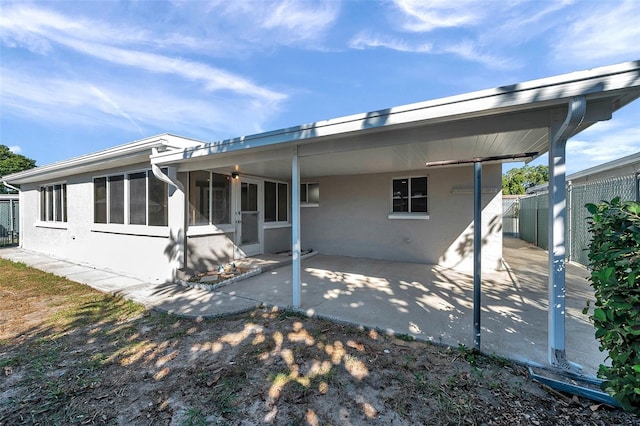 rear view of property featuring a sunroom and a patio