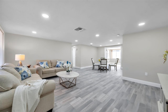 living room with light hardwood / wood-style flooring