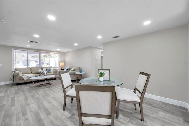 dining space with light wood-type flooring