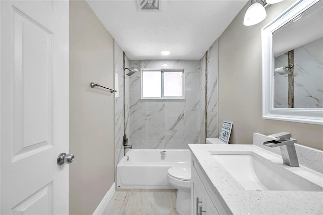 full bathroom featuring vanity, toilet, and tiled shower / bath combo