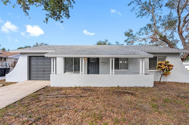 single story home featuring a porch and a garage