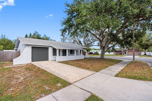 ranch-style house featuring a front yard and a garage