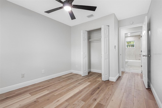 unfurnished bedroom featuring ceiling fan, a closet, and light wood-type flooring