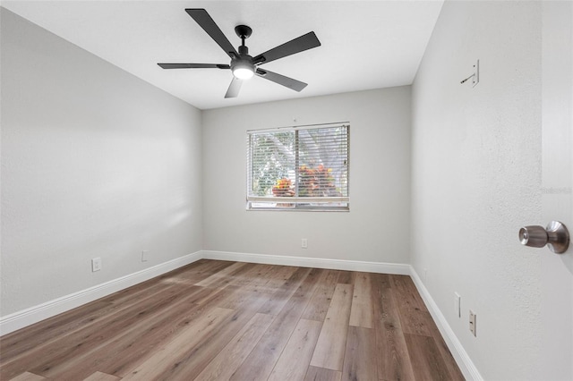 spare room featuring light wood-type flooring and ceiling fan